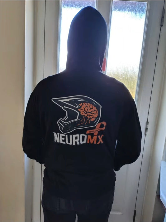 Person in black hoodie with motocross helmet and brain graphic, NEUROMX and ADHD awareness design
