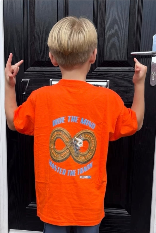 Child wearing orange motocross T-shirt with 'Ride the Mind, Master the Track' design